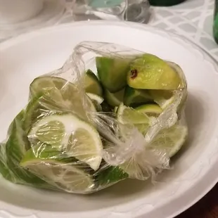 a bowl of fruit wrapped in plastic