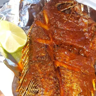 grilled fish with a lime wedge