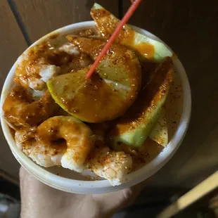 a hand holding a bowl of food