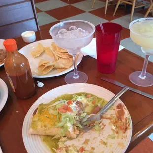 Half-eaten burrito with one margarita left to go.