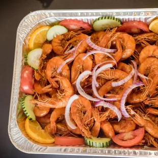 a tray of shrimp and vegetables