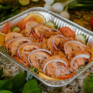 a tray of shrimp and vegetables