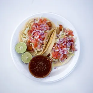 a plate of tacos and salsa