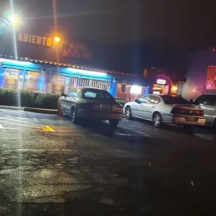 cars parked in a parking lot at night