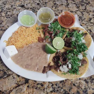 Tacos with a side of rice and beans