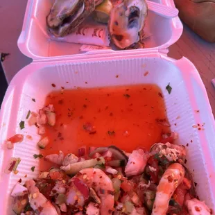 two takeout containers of seafood