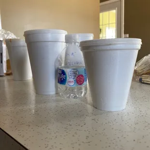 three cups of water on a counter