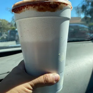 a hand holding a cup of coffee