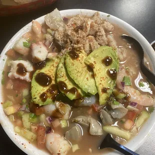 Cocktails Mixto. Shrimp (cooked) Shrimp curtido, octopus, sea snail, fresh crab, and veggies. Topped with avocado and spicy tangy sauce.