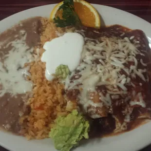 Enchiladas, rice, and beans.