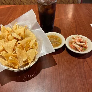 a bowl of chips and a bowl of salsa