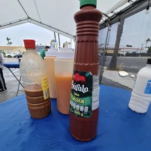 a bottle of hot sauce and a bottle of ketchup