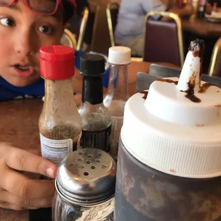 a child sitting at a table in a restaurant