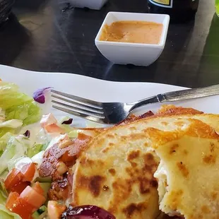 a plate of food and a bottle of beer