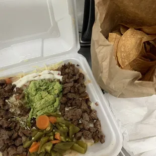 Carne Asada Nachos with Salsa and chips on the side.