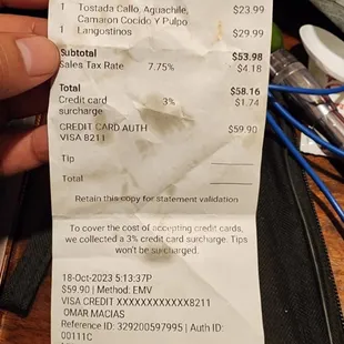 a hand holding a receipt