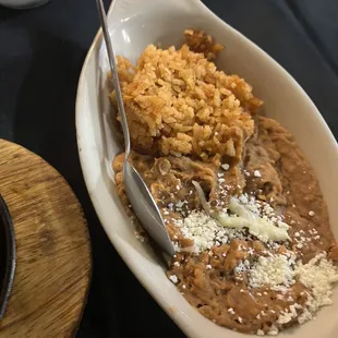 Rice and beans that come with fajitas.