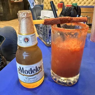 a bottle of modelo and a bloody drink