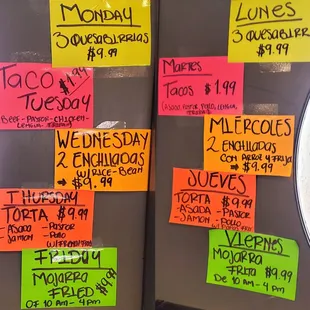 The weekday specials listed on the inside of the front doors. M: Quesabirrias, T: Tacos, W: Enchiladas, Th: Torta, F: Mojarra Fried.