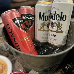 a bucket full of cans of modelo