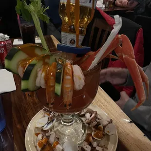 a shrimp cocktail with shrimp, cucumbers, and sauce