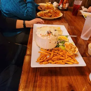 a woman sitting at a table with a plate of food