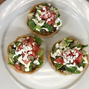 three appetizers on a white plate