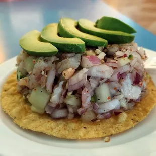 a tortilla topped with crab and avocado