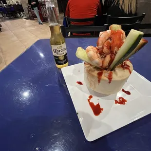 a plate of food and a bottle of beer