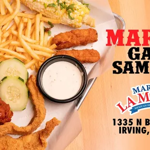 a plate of food with fries, pickles, and a sandwich