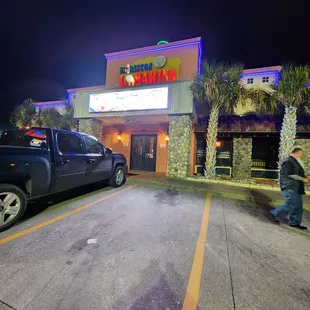 a man skateboarding in front of a restaurant