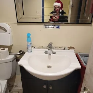 a man taking a selfie in a bathroom mirror