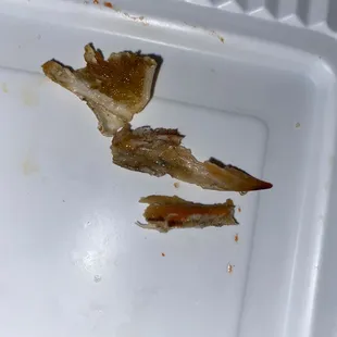 a piece of fish that has been left in a styrofoam container