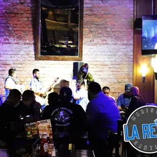 a group of people sitting at a bar