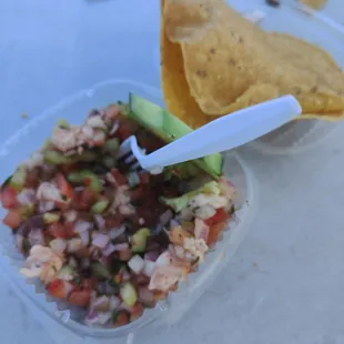 a bowl of salsa and a tortilla