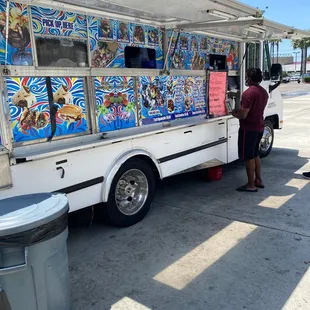 a woman ordering food from a food truck