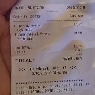 a hand holding a receipt