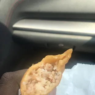 a hand holding a pastry