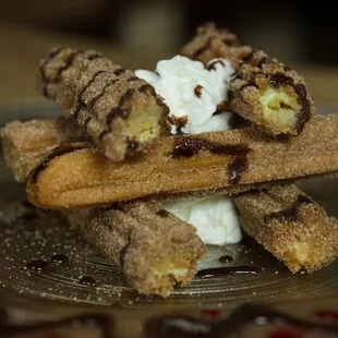 a waffle with whipped cream and chocolate sauce