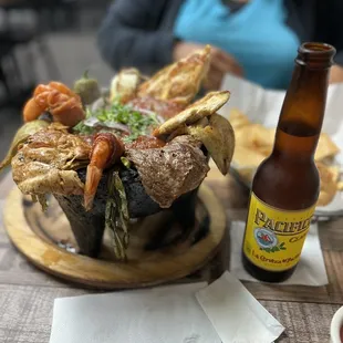 Molcajeté Mar y Tierra with a beer