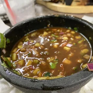 4/5 of the bowl filled with lime juice concentrate mixed with a hot sauce and chopped everything else but what the menu stated.
