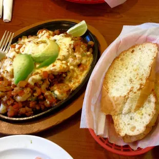 Camarones Jarochos. Parrillada with small sweet shrimp, tomato, onion, bacon and muenster cheese. French bread side. Incredible!