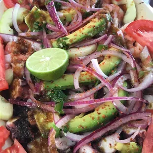 One of our classic and fan favorites. Half shrimp and half octopus topped with avocado onion and our signature sauce.