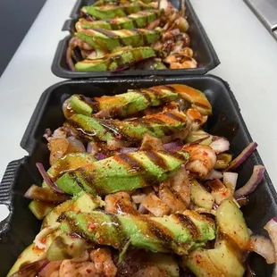 a row of trays of food