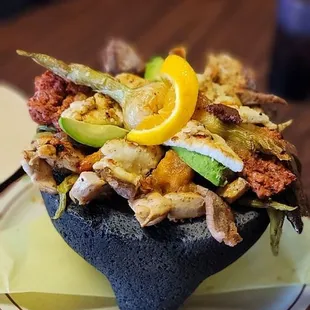 Seafood Molcajete mix. Comes with fish, shrimp, grilled chicken, chorizo, cubed cheese, nopales (cactus) and green onio a must share