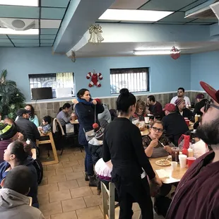 a group of people sitting at tables in a restaurant