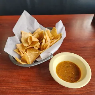 a bowl of chips and a bowl of salsa