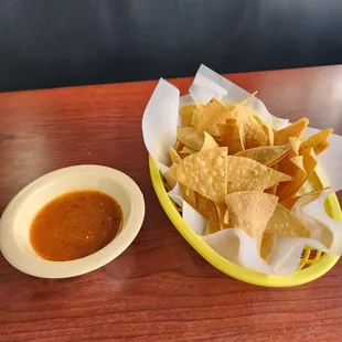 a bowl of chips and a bowl of salsa