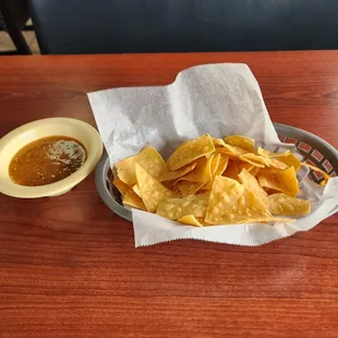 a bowl of chips and a bowl of salsa