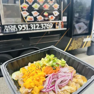a hand holding a container of food